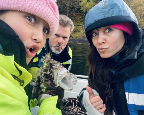 Mother and daughter and funny fish, on viking fishing adventure in sognefjord with captain Tor