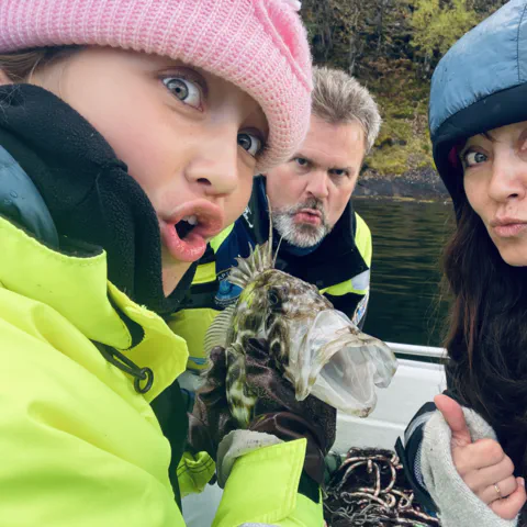 Mother and daughter and funny fish, on viking fishing adventure in sognefjord with captain Tor